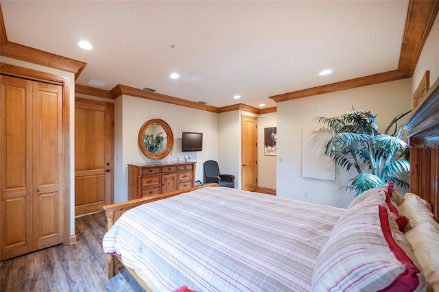 bedroom featuring crown molding and dark wood-type flooring