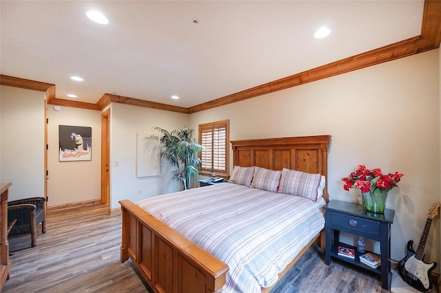 bedroom featuring hardwood / wood-style floors and ornamental molding