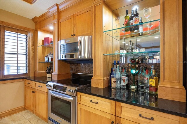 1653 N US Highway 1 Unit 201, Ormond Beach, FL 32174 - kitchen featuring stainless steel appliances, open shelves, dark stone counters, and tasteful backsplash