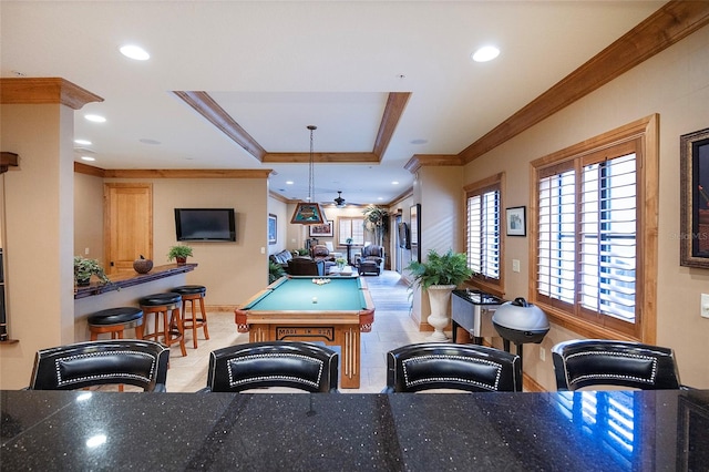 game room with a raised ceiling, ceiling fan, ornamental molding, and pool table