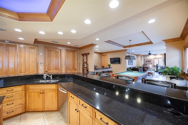 1653 N US Highway 1 Unit 201, Ormond Beach, FL 32174 - kitchen with a raised ceiling, a ceiling fan, crown molding, open floor plan, and dark stone counters