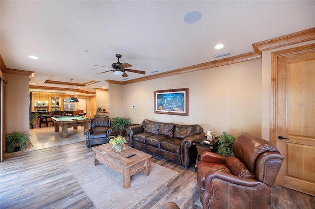 living room with crown molding, ceiling fan, wood-type flooring, and billiards