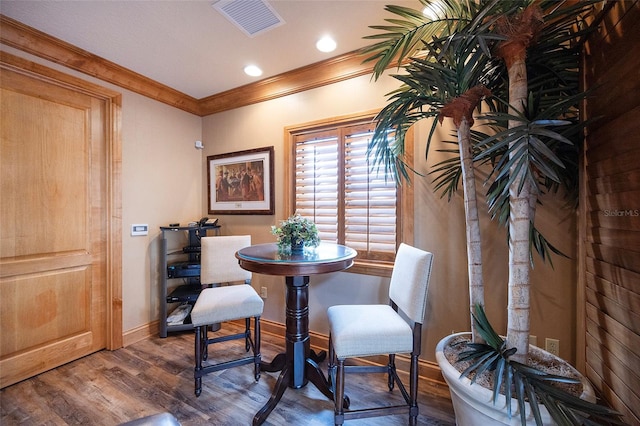 dining area featuring crown molding and dark hardwood / wood-style flooring