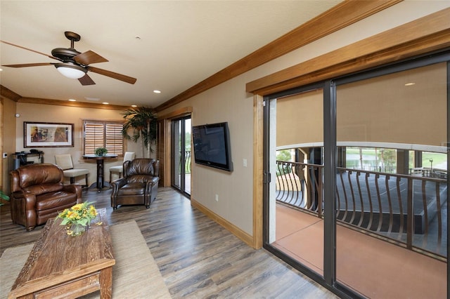 living room featuring ceiling fan, crown molding, a healthy amount of sunlight, and hardwood / wood-style flooring