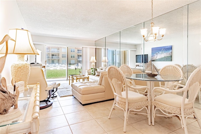 dining area with light tile patterned floors, a textured ceiling, and a notable chandelier