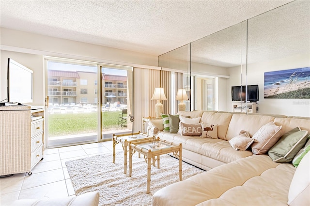 living room featuring light tile patterned floors, a textured ceiling, and a wealth of natural light