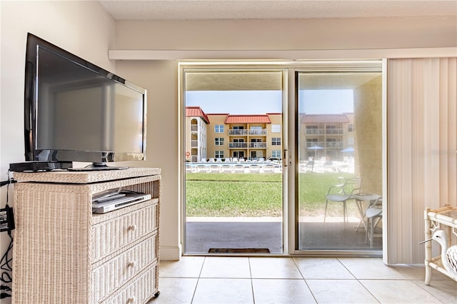 doorway with plenty of natural light and light tile patterned floors