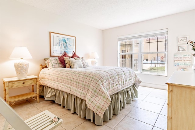 bedroom with a textured ceiling and light tile patterned flooring