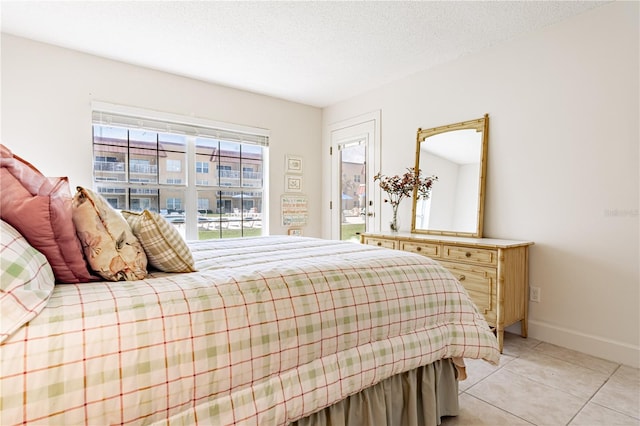 bedroom with light tile patterned flooring and a textured ceiling