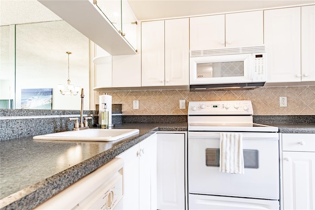 kitchen featuring decorative backsplash, white cabinetry, sink, and white appliances