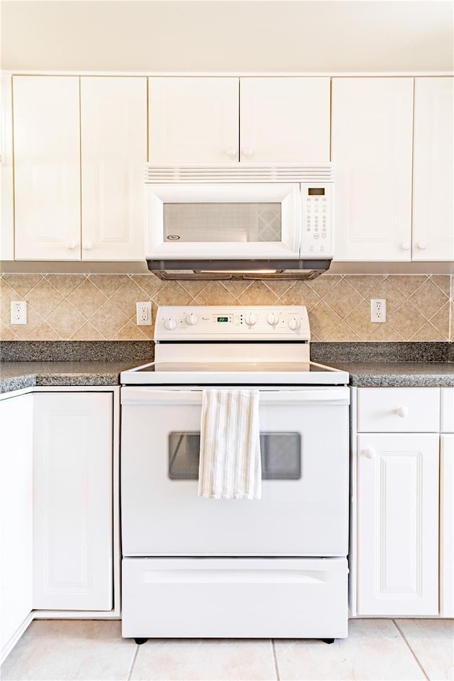 kitchen with white cabinets, decorative backsplash, and white appliances