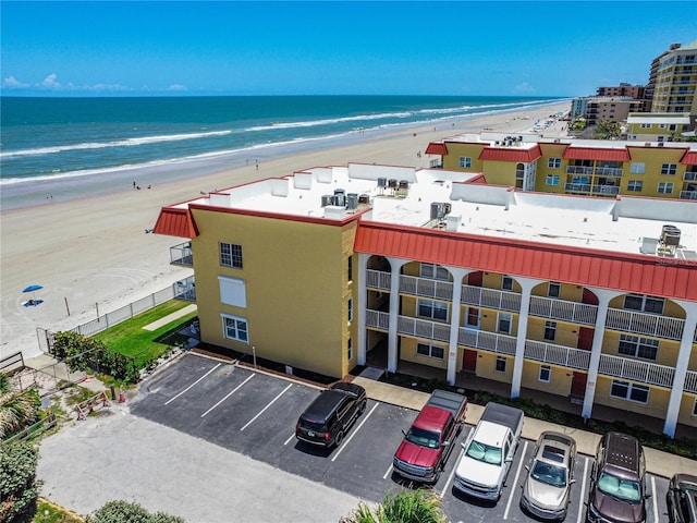 drone / aerial view featuring a water view and a view of the beach