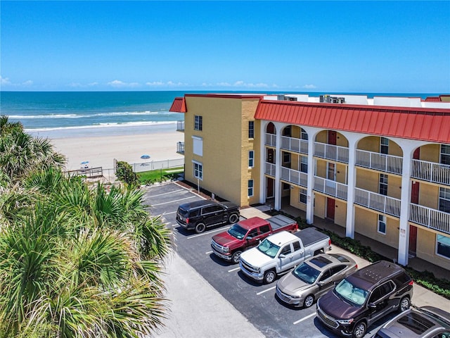 view of property with a beach view and a water view