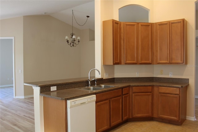 kitchen featuring kitchen peninsula, white dishwasher, sink, an inviting chandelier, and hanging light fixtures