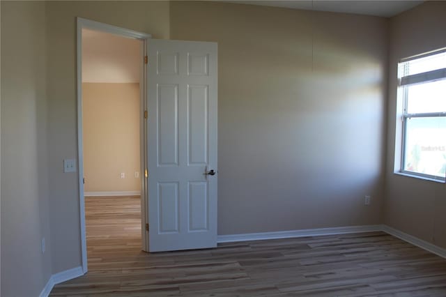 unfurnished room featuring light hardwood / wood-style flooring and a healthy amount of sunlight