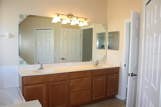 bathroom featuring tile patterned floors, a tub to relax in, and vanity