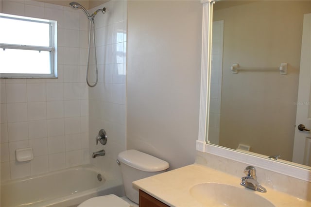 full bathroom featuring vanity, toilet, and tiled shower / bath