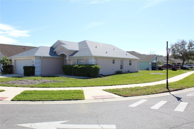 view of front facade featuring a garage, a front lawn, and stucco siding