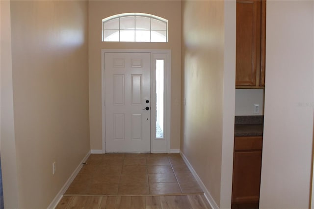 entrance foyer featuring light tile patterned floors and baseboards