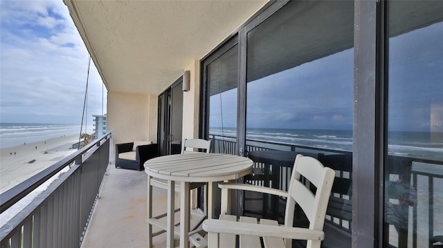 balcony with a beach view and a water view