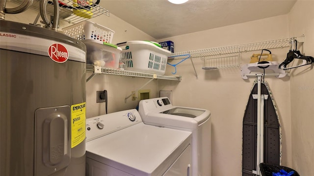 laundry room featuring washing machine and clothes dryer and water heater