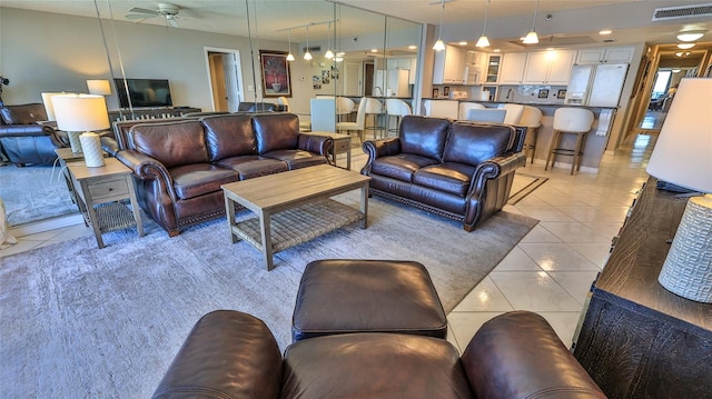 living room featuring ceiling fan and light tile patterned floors