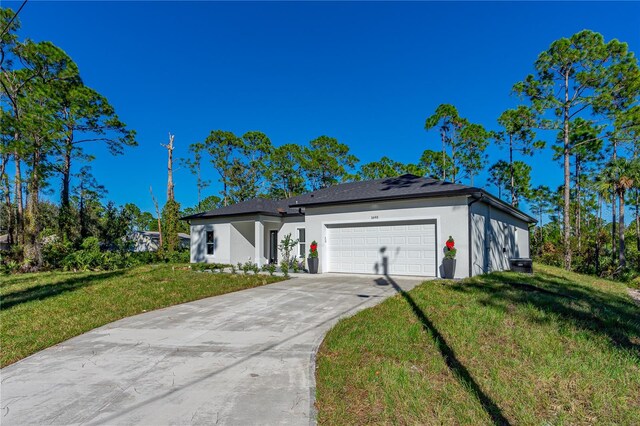 view of front facade with a garage and a front lawn