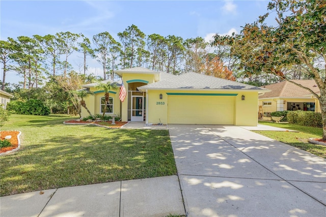 view of front of home with a garage and a front lawn