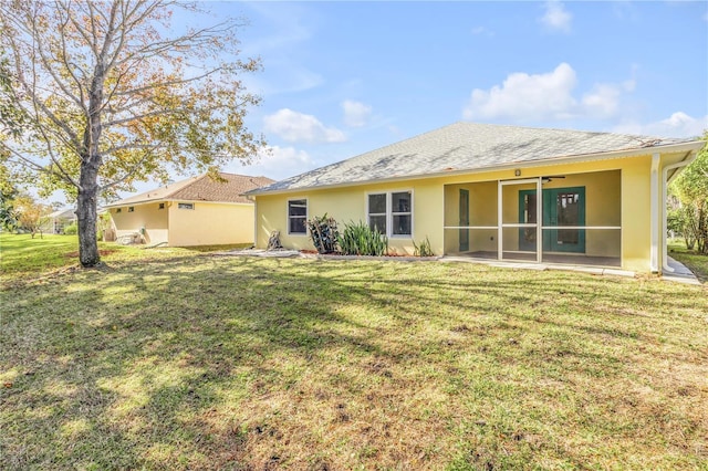 back of house featuring a sunroom and a yard