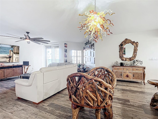 living room featuring wood-type flooring and ceiling fan with notable chandelier