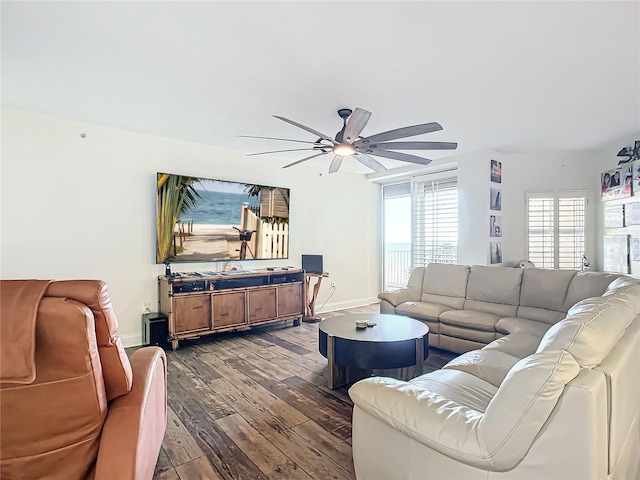 living room with ceiling fan and dark wood-type flooring