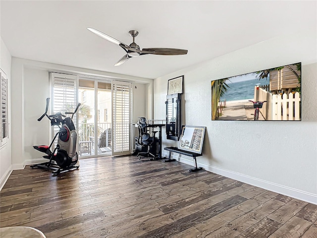 exercise area featuring dark hardwood / wood-style floors and ceiling fan