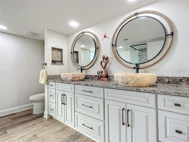 bathroom featuring vanity, toilet, and wood-type flooring