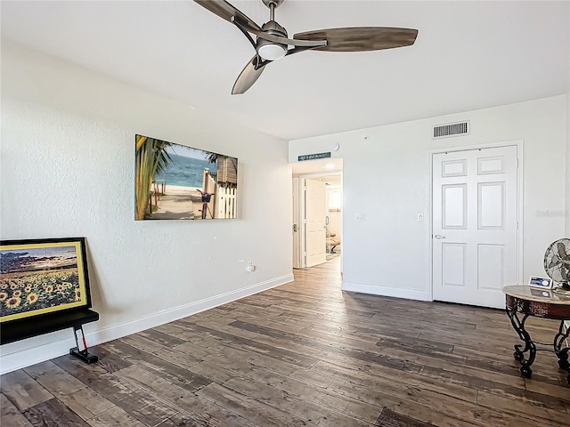 interior space featuring ceiling fan and dark hardwood / wood-style floors