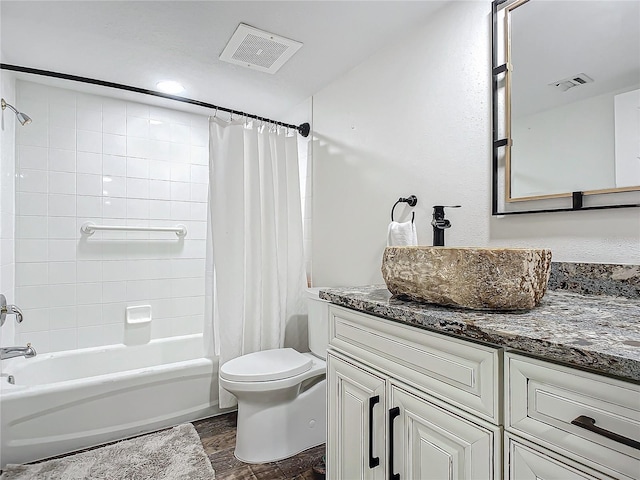 full bathroom featuring hardwood / wood-style floors, vanity, toilet, and shower / bath combo with shower curtain