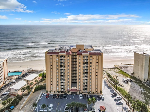 birds eye view of property with a view of the beach and a water view