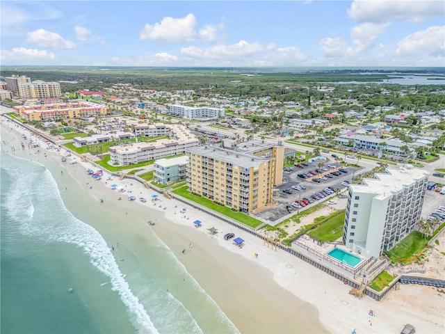 birds eye view of property featuring a beach view and a water view