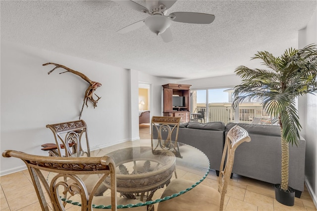 tiled living room with a textured ceiling and ceiling fan