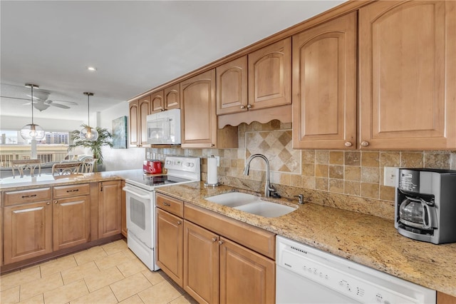 kitchen featuring pendant lighting, white appliances, sink, ceiling fan, and light stone counters