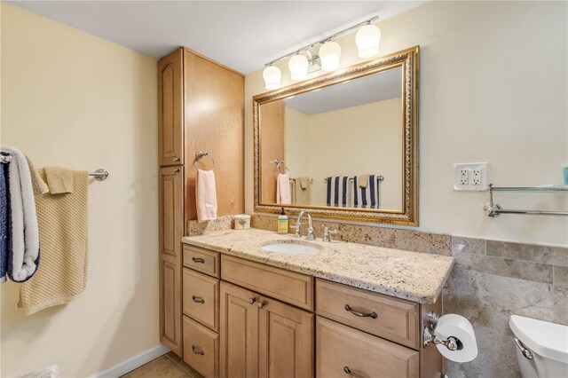 bathroom featuring tile patterned flooring, vanity, and toilet