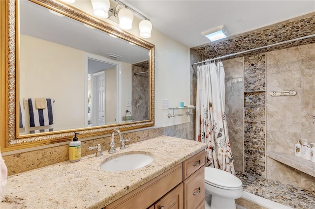 bathroom with a shower with curtain, vanity, and toilet