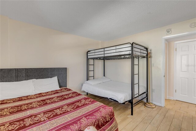 bedroom featuring hardwood / wood-style floors and a textured ceiling