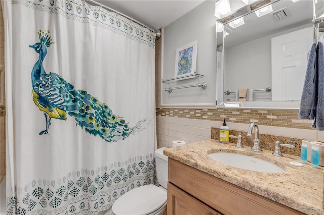 bathroom featuring curtained shower, vanity, and toilet