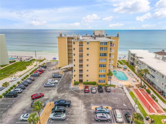 drone / aerial view with a water view and a view of the beach