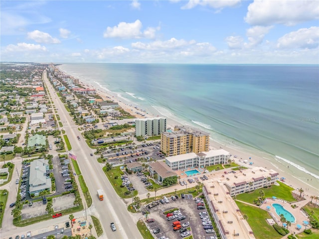 drone / aerial view featuring a water view and a beach view