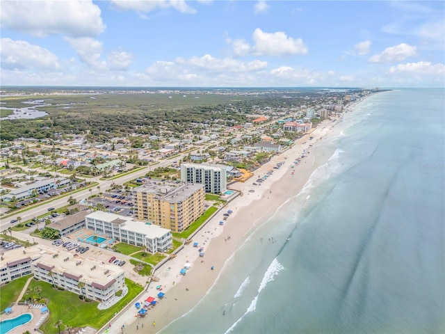 drone / aerial view featuring a water view and a beach view