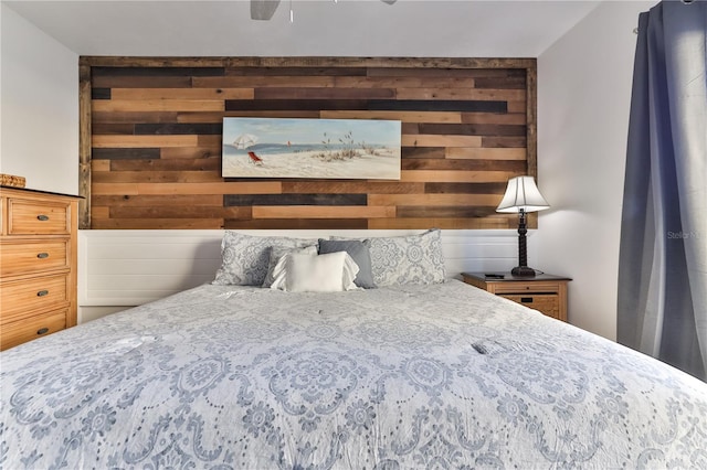 bedroom with wood walls