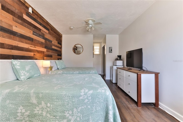 bedroom with dark hardwood / wood-style floors and ceiling fan