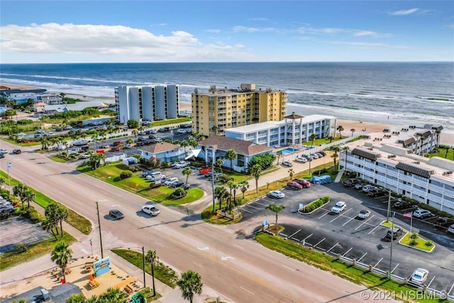 aerial view with a water view and a view of the beach