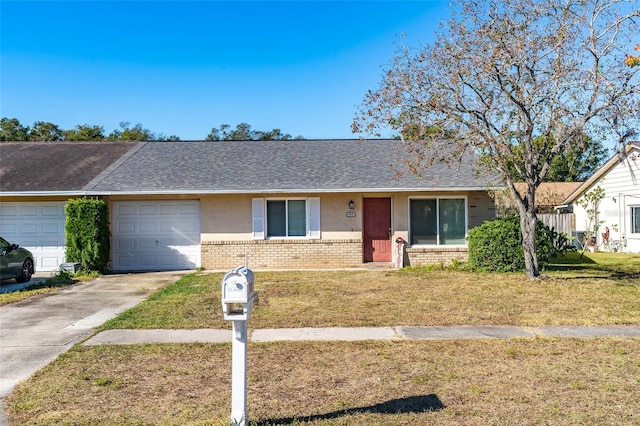 single story home featuring a garage and a front lawn